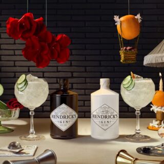 Hendrick's: Two bottles of Hendrick's Gin - one white and one black each with a cocktail beside it and cucumber, roses and an orange in the background