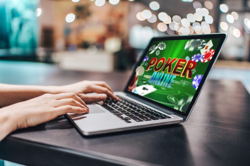 Online Casino Market: Close up cropped photo of girl hands using her laptop for playing poker online.