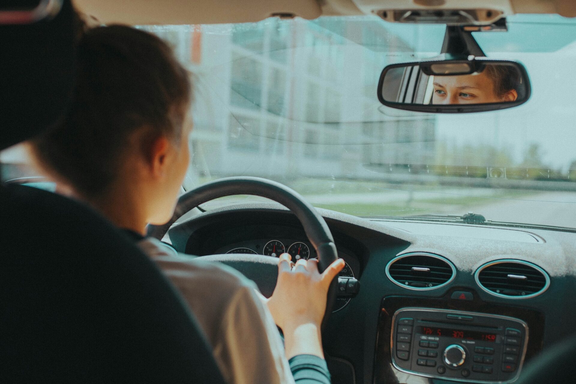 Driving School: Teenager behind the wheel of the car (interior shot)