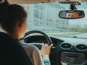 Driving School: Teenager behind the wheel of the car (interior shot)