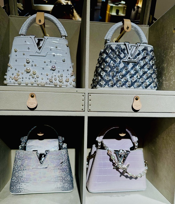 Savoir-Faire Toronto: Four miniature Capucines bags displayed in a trunk