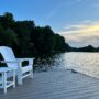 RTDs: White Muskoka Chair and table by lake