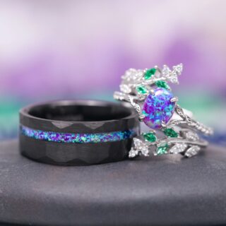 Same Stone: matching nature-inspired couples' wedding ring set from Aquamarise Lavender Opal & Emerald Fairy Leaf collection men's wedding band and woman's ring stacked near each other