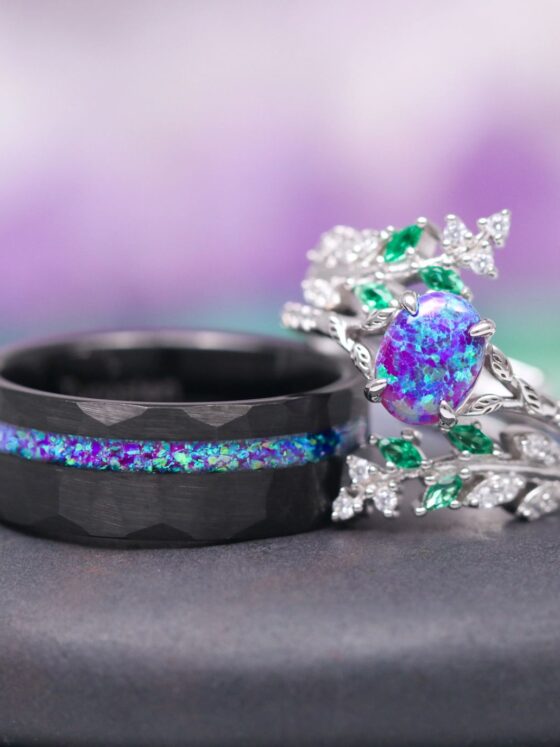 Same Stone: matching nature-inspired couples' wedding ring set from Aquamarise Lavender Opal & Emerald Fairy Leaf collection men's wedding band and woman's ring stacked near each other