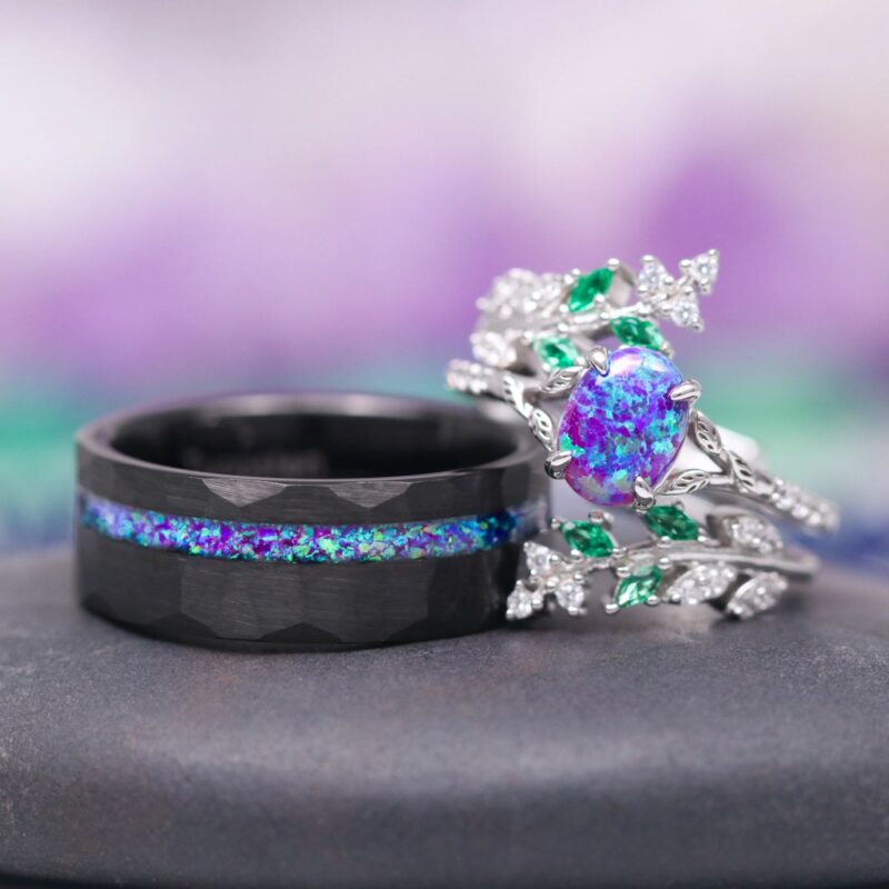 Same Stone: matching nature-inspired couples' wedding ring set from Aquamarise Lavender Opal & Emerald Fairy Leaf collection men's wedding band and woman's ring stacked near each other