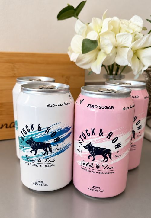 RTDs: Stock & Row Slow & Low + Cold Tea Black Raspberry on table next to white flowers