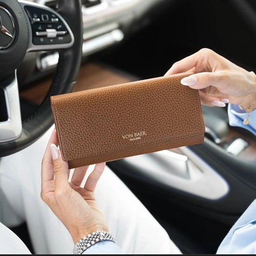 Gifts for your Mother-in-Law: woman in a car holding a brown wallet