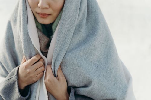 Gifts for your Mother-in-Law: Woman wrapped in a grey scarf
