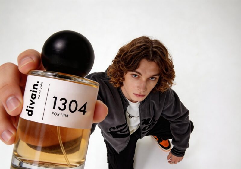 Perfume Dupes: Man with long hair holding a bottle of divain. 1304