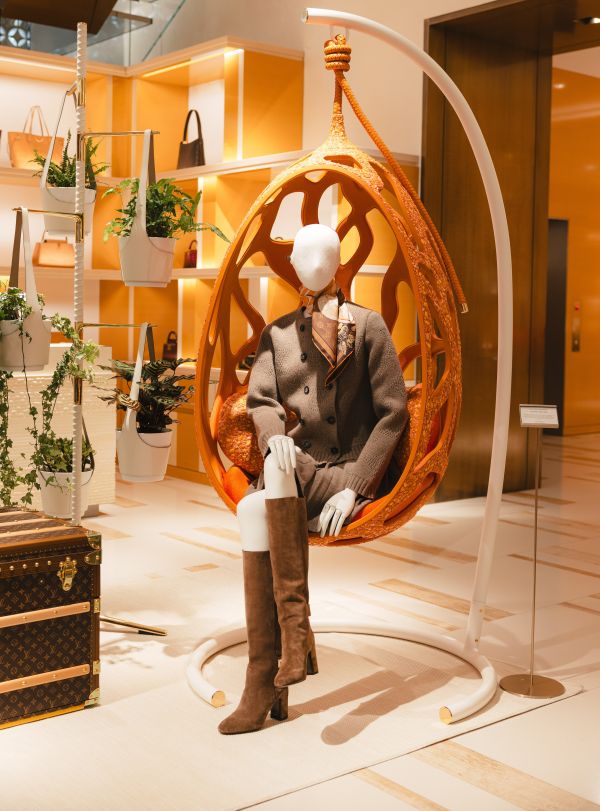Savoir-Faire Toronto: Cocoon Couture Curupira Chair in orange with mannequin seated