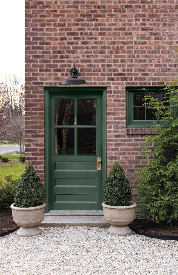 Webster Green: Exterior green door against a brick house